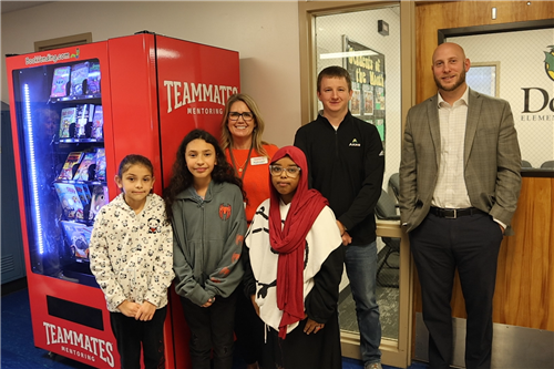 Students and TeamMates Board members posing with new book vending machine at Dodge Elementary.